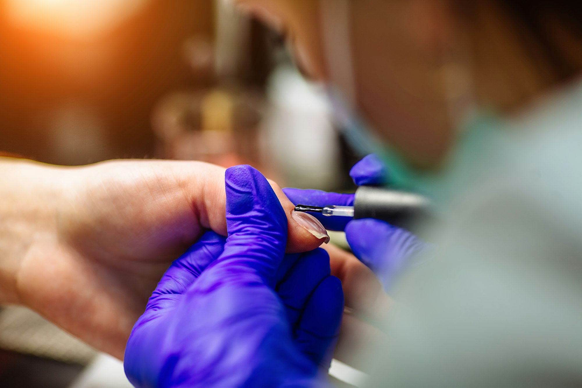 Nail care in salon. Selective focus on costumer's nails. Selective focus